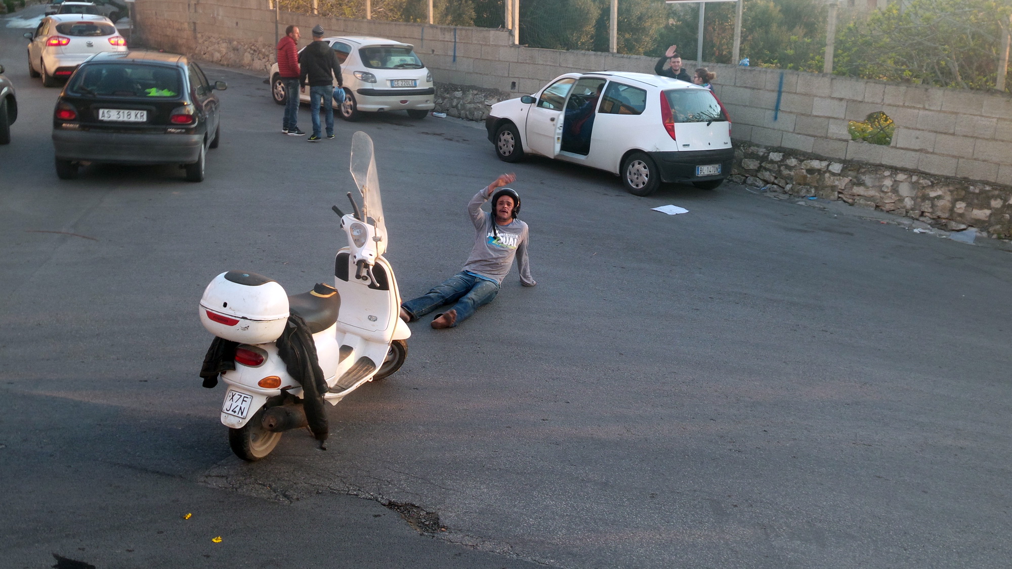 Straniero in scooter reagisce allo stop dei vigili: si accascia a terra e inveisce